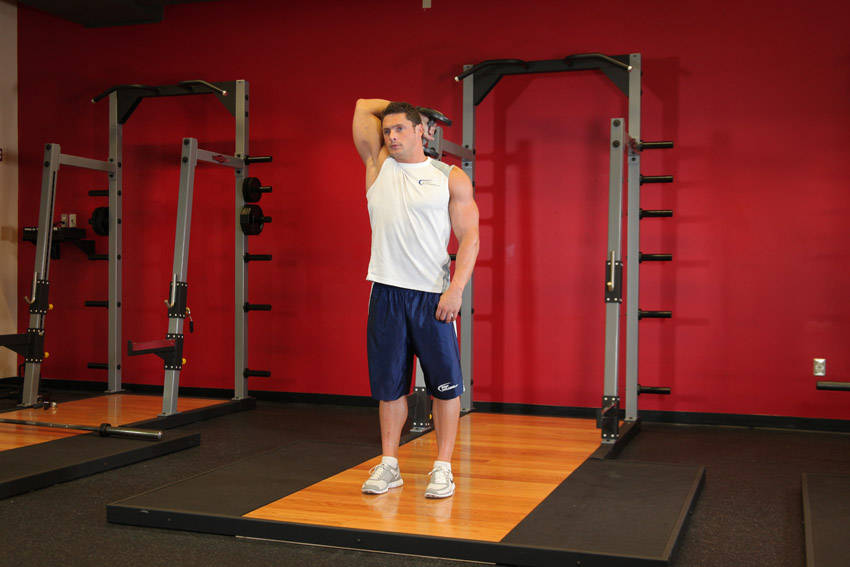 Standing One-Arm Dumbbell Triceps Extension, end position